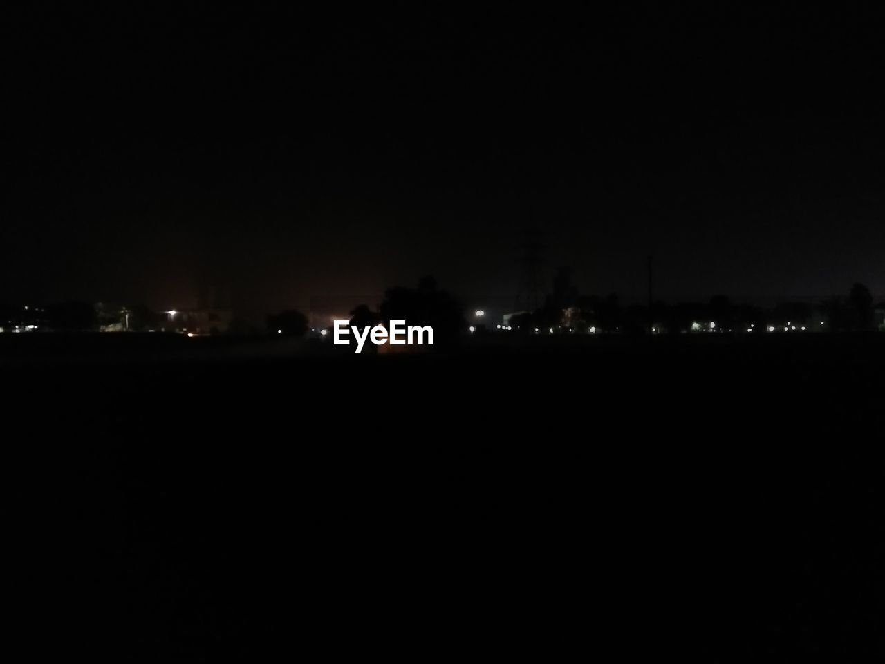 ILLUMINATED CITYSCAPE AGAINST SKY