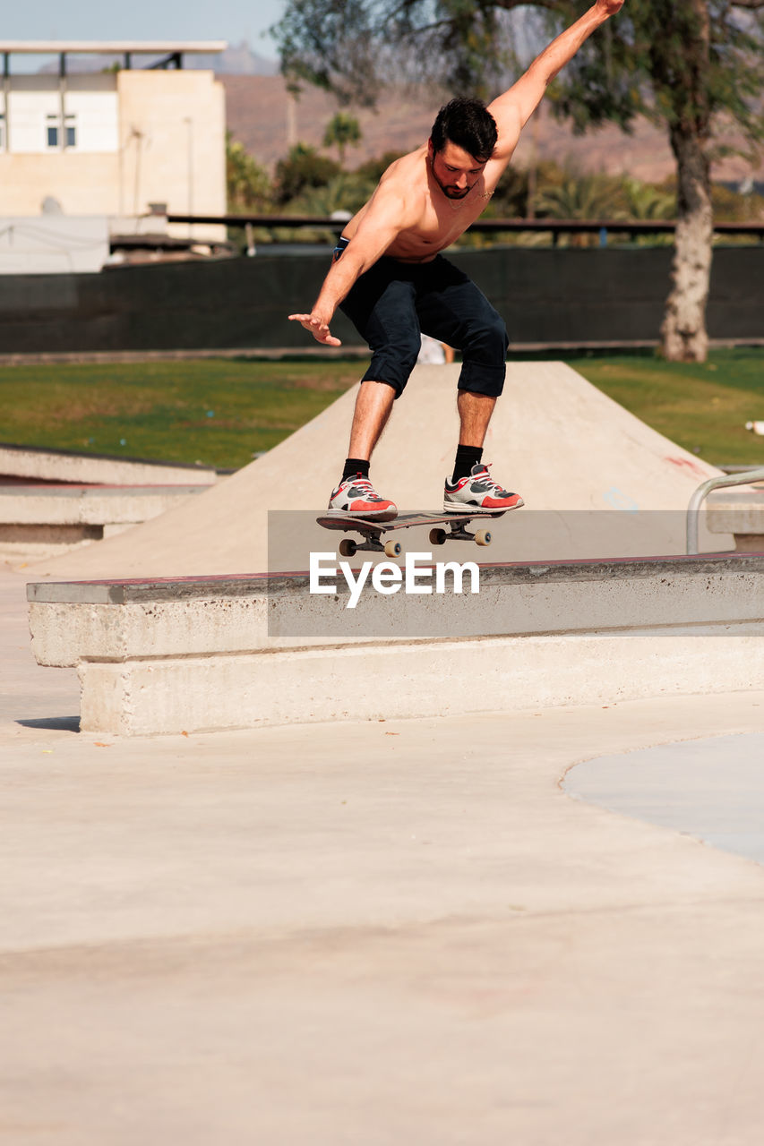 Boy doing skateboard trick on rail