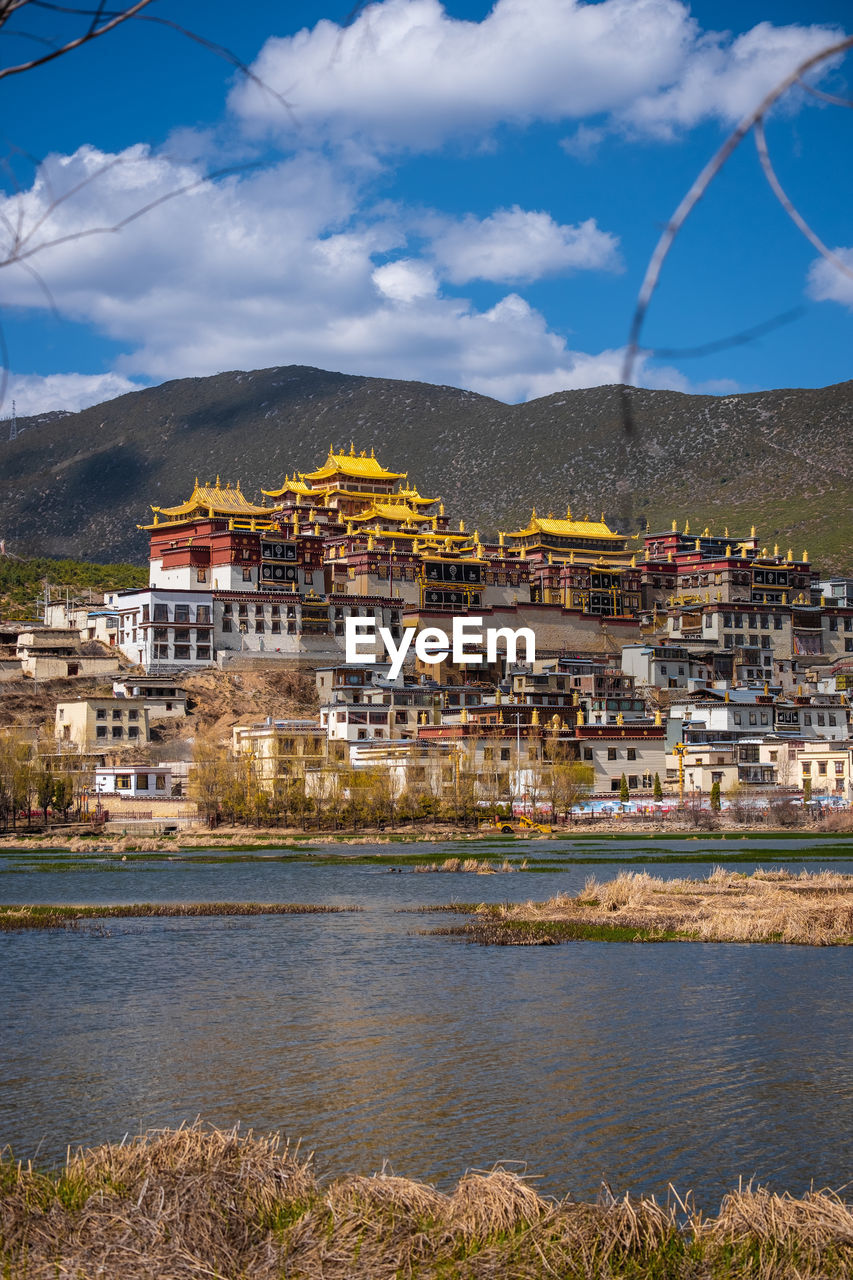 TOWN BY RIVER AND BUILDINGS IN CITY