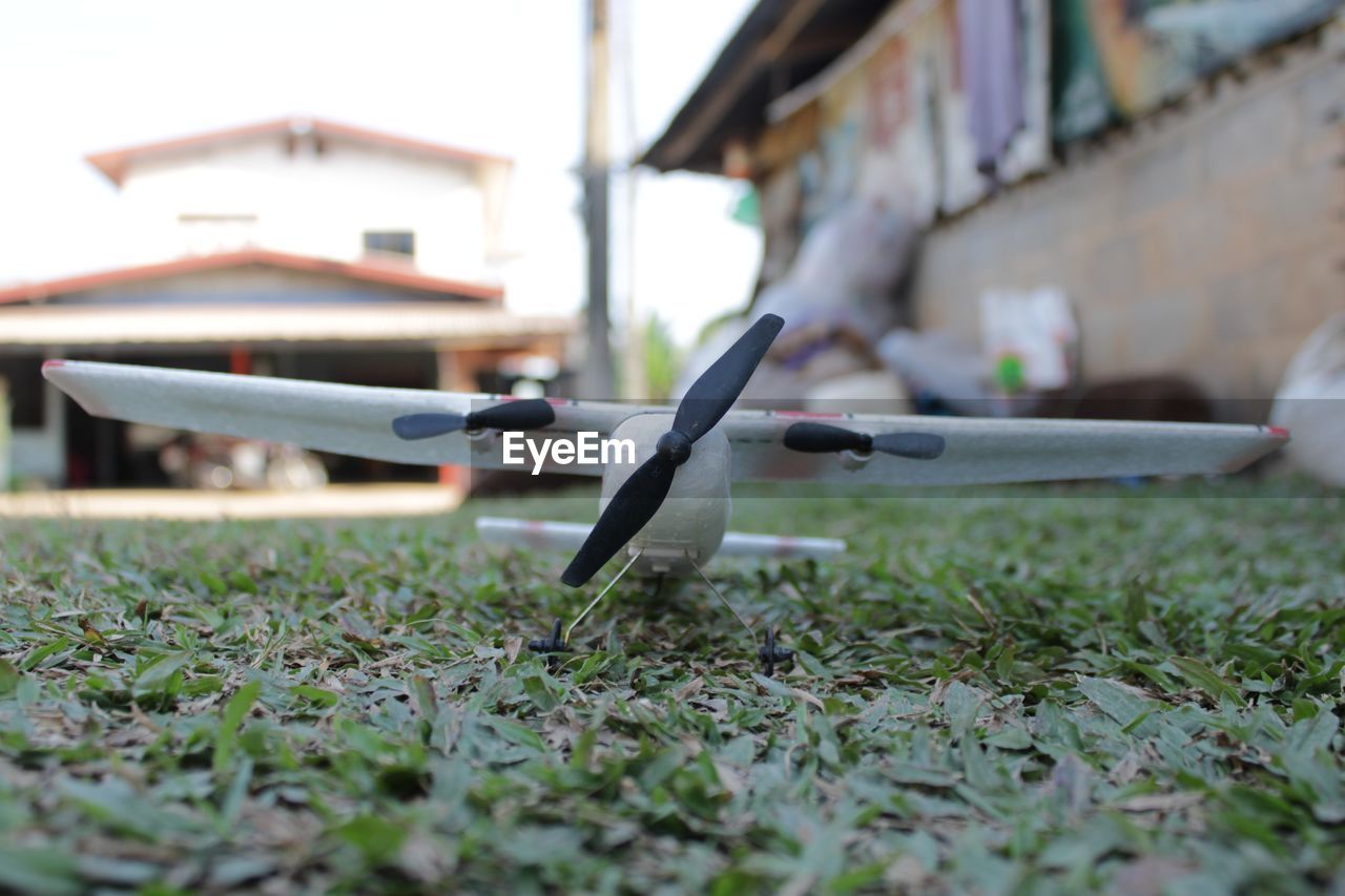 airplane, aircraft, vehicle, day, wing, architecture, aviation, grass, no people, selective focus, nature, built structure, mode of transportation, outdoors, air vehicle, building exterior, plant