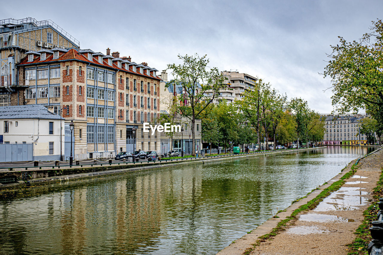 canal amidst buildings in city