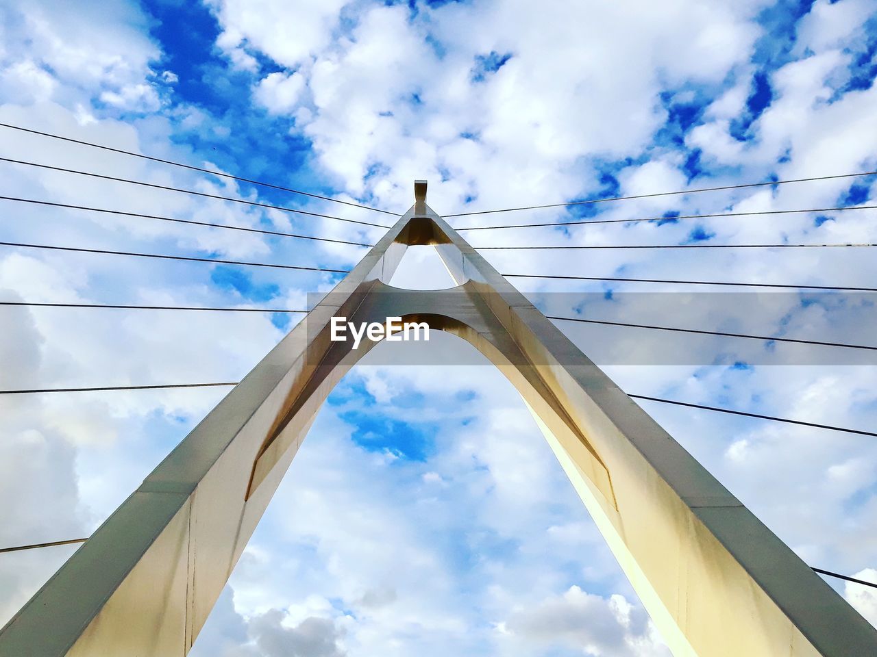 DIRECTLY BELOW SHOT OF BRIDGE AGAINST SKY