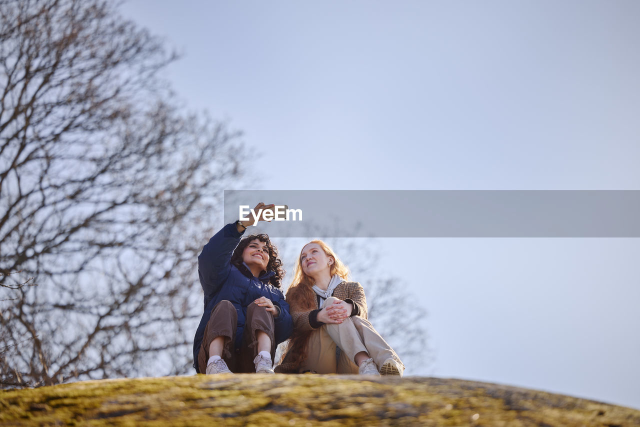 Young women taking selfie in park