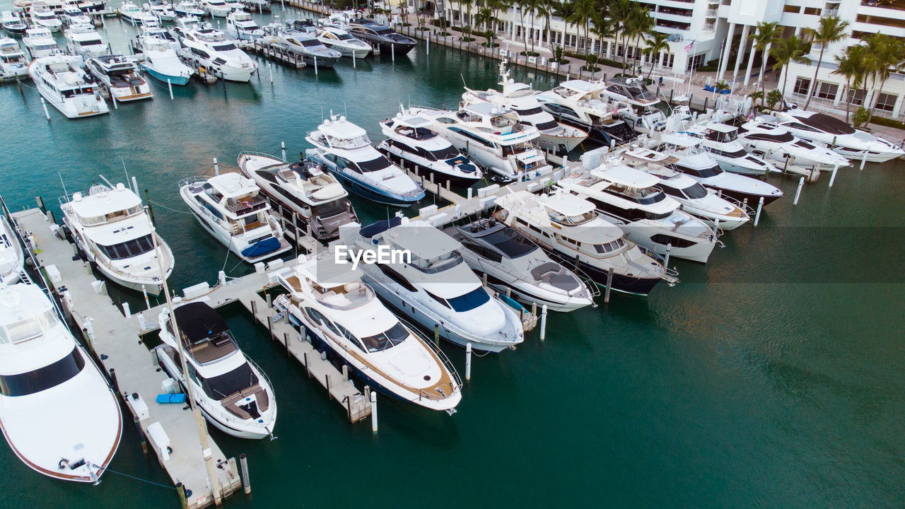 water, marina, nautical vessel, dock, moored, transportation, harbor, mode of transportation, port, high angle view, no people, ship, architecture, sea, vehicle, pier, travel destinations, nature, boat, day, travel, building exterior, yacht, city, outdoors, built structure, building, in a row, tourism, waterfront, aerial view, watercraft