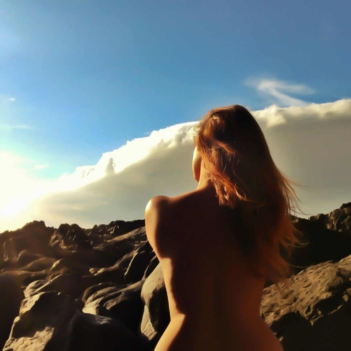 WOMAN LOOKING AT MOUNTAIN