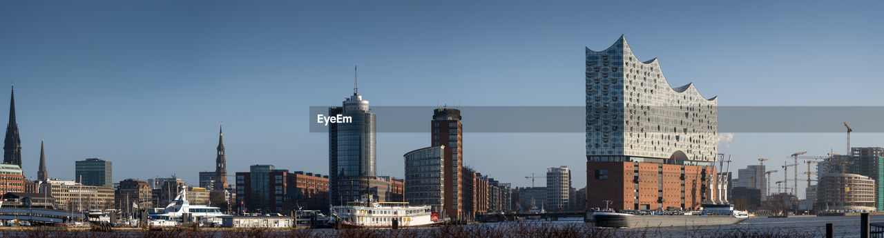 Modern buildings in city against clear sky