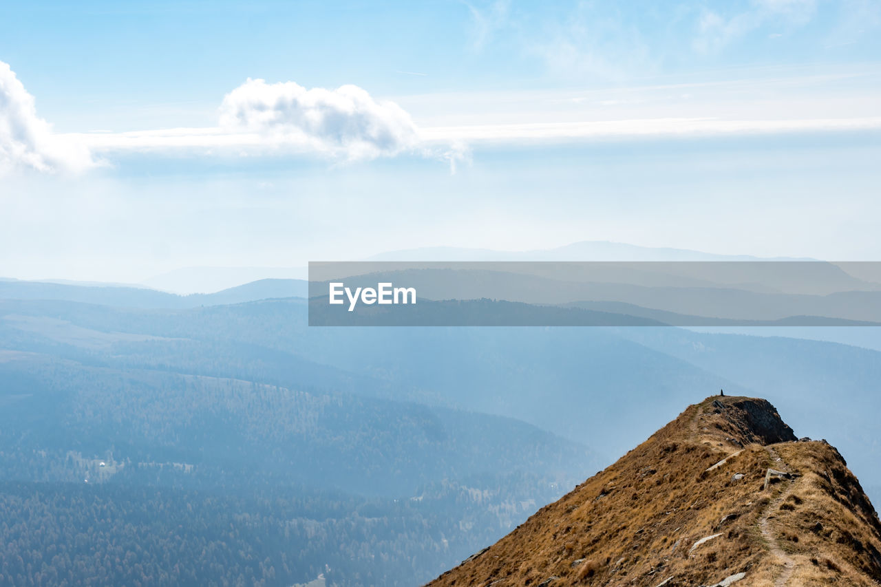 Scenic view of mountains against cloudy sky