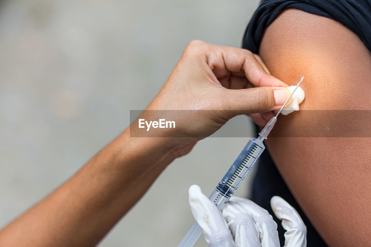 Close-up of doctor giving injection to patient