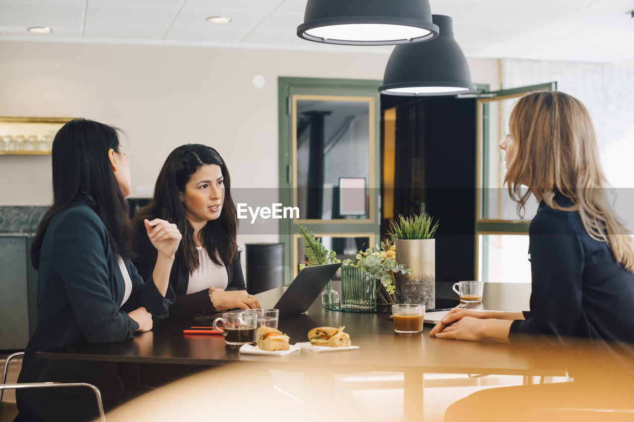 Business colleagues discussing in meeting at board room