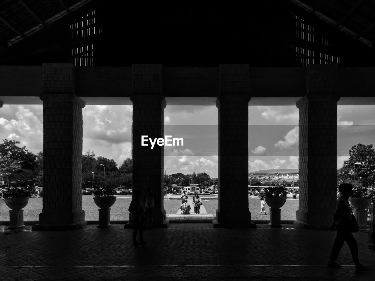 People seen through architectural columns