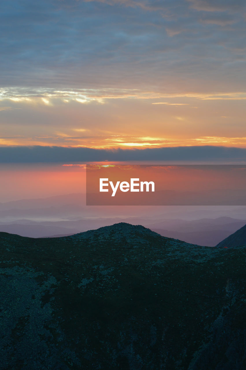 Scenic view of silhouette mountain against sky during sunset