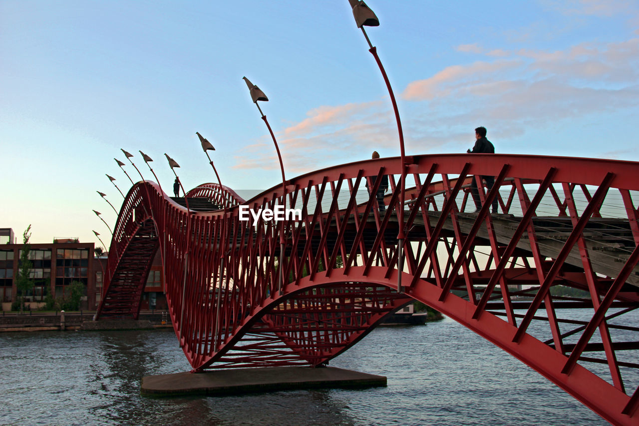 Bridge over river against built structures