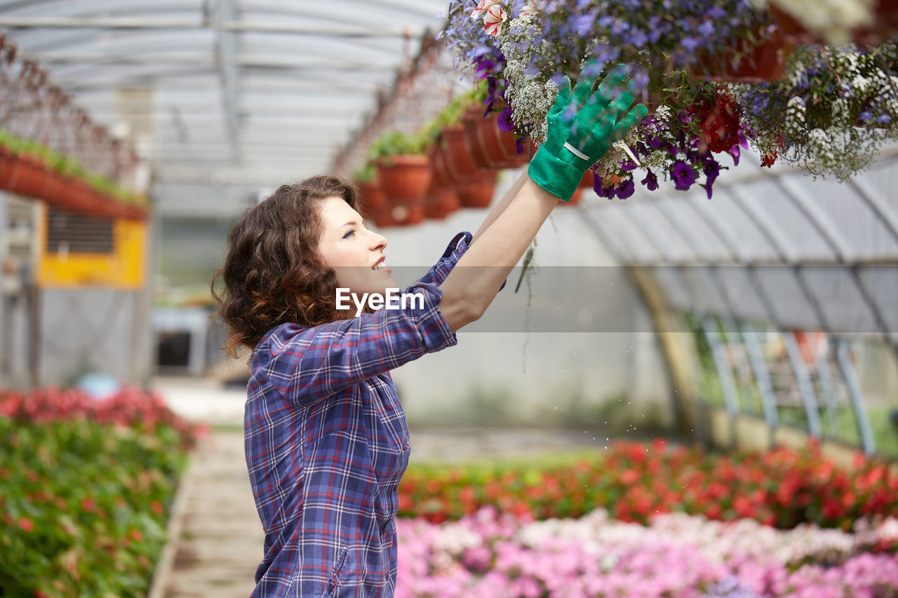 Woman working in greenhouse