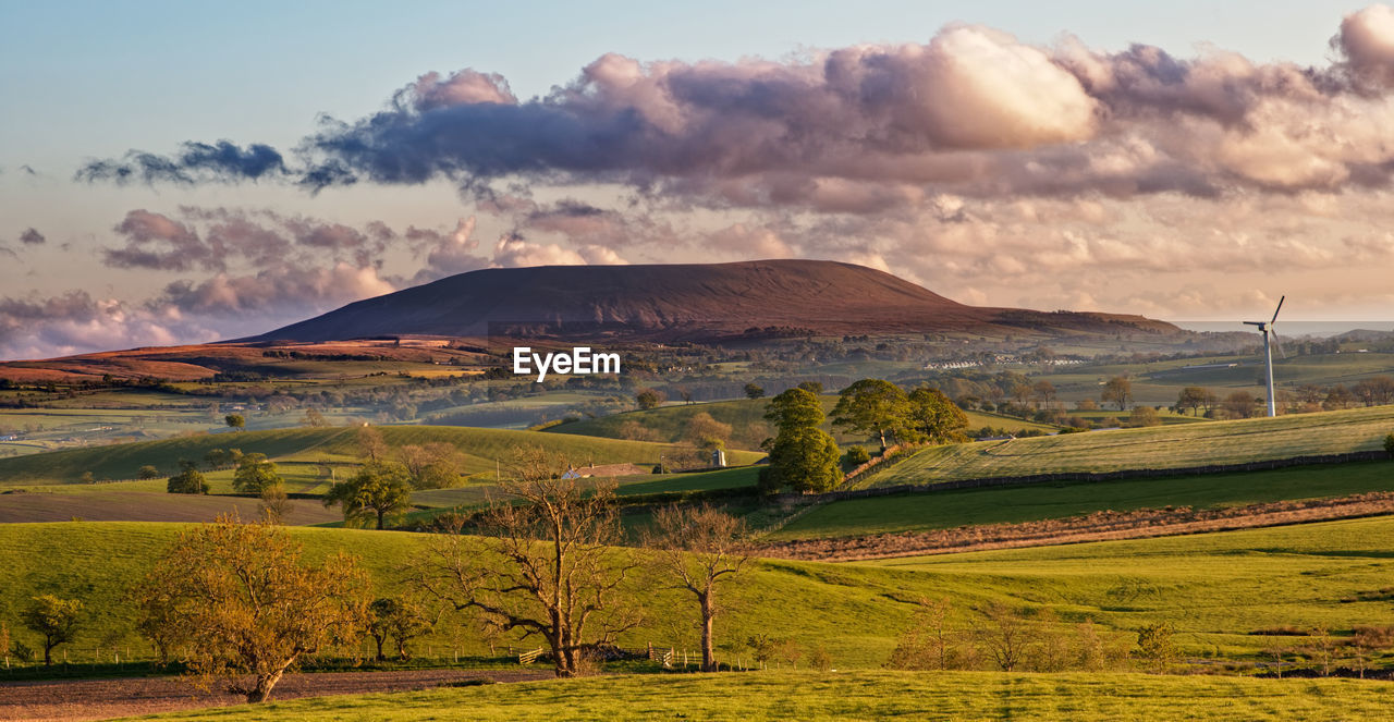 landscape, environment, land, sky, nature, scenics - nature, morning, beauty in nature, mountain, rural scene, rural area, plain, cloud, plant, field, agriculture, horizon, tranquility, grass, no people, grassland, tree, tranquil scene, prairie, travel destinations, farm, dawn, non-urban scene, outdoors, travel, sun, sunlight, social issues, mountain range, plateau, environmental conservation, idyllic, sunrise, crop, valley, tourism, day, dramatic sky, panoramic, green, water, springtime