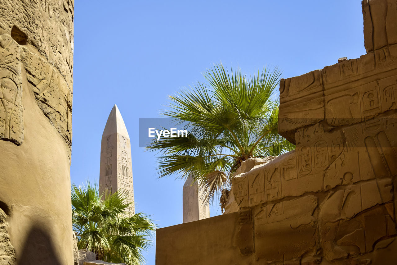 Ruins of karnak temple complex with columns carved with ancient hieroglyphs. luxor, egypt.