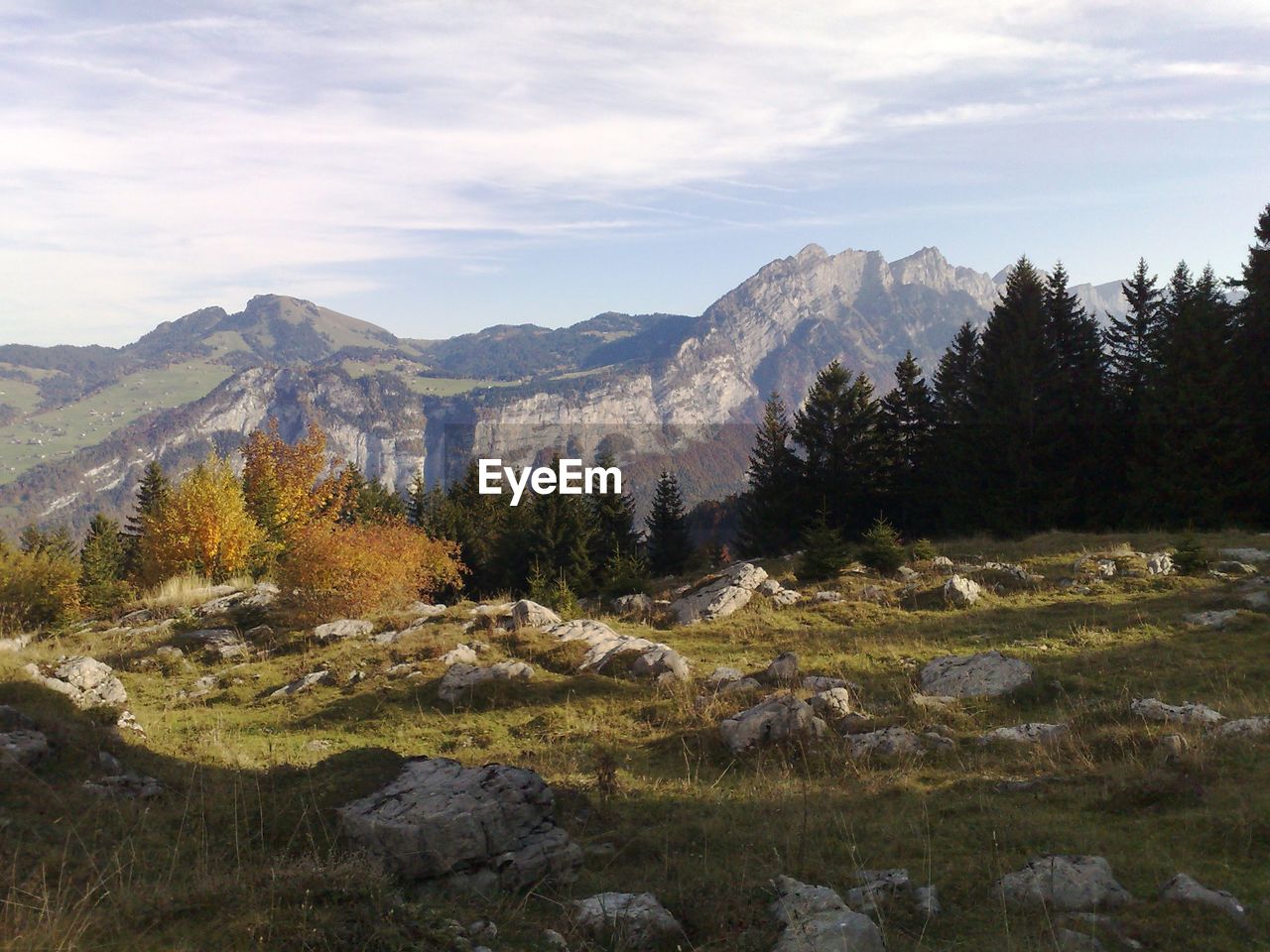 Scenic view of mountains against cloudy sky