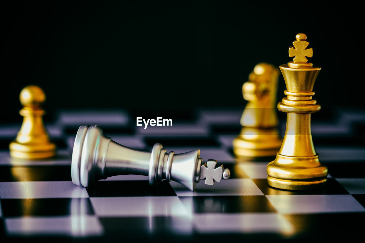 Close-up of chess pieces against black background