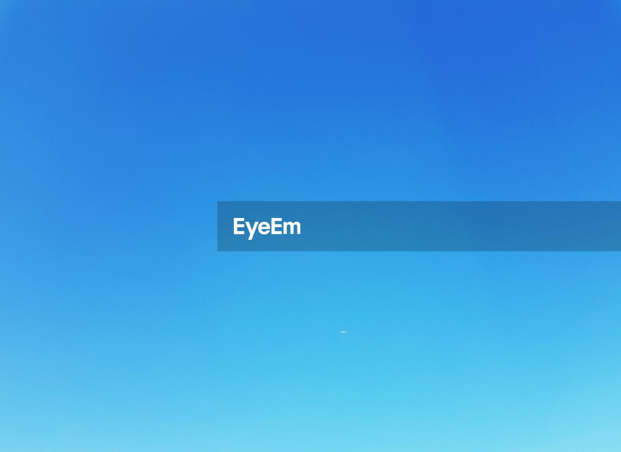 LOW ANGLE VIEW OF MOON IN CLEAR BLUE SKY