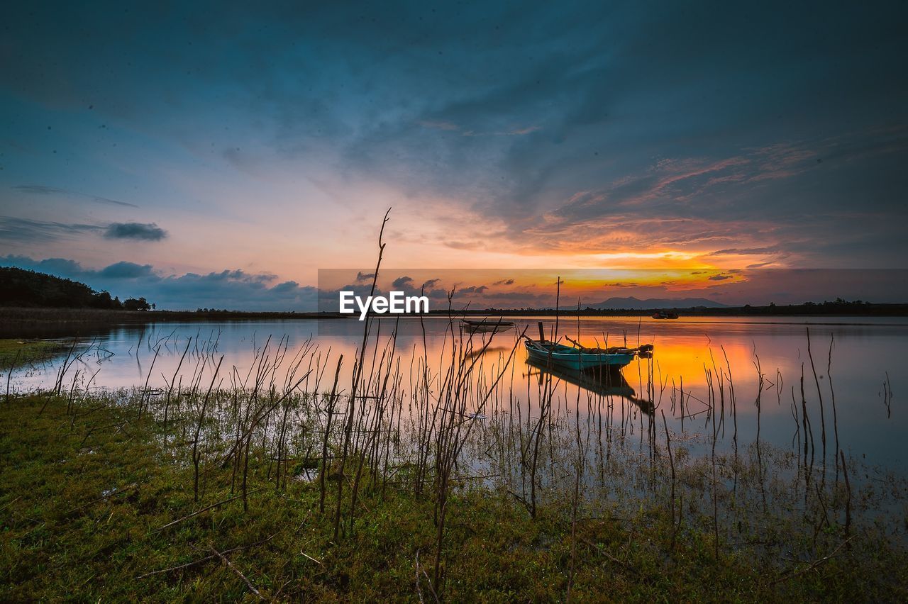 Scenic view of lake against sky during sunset