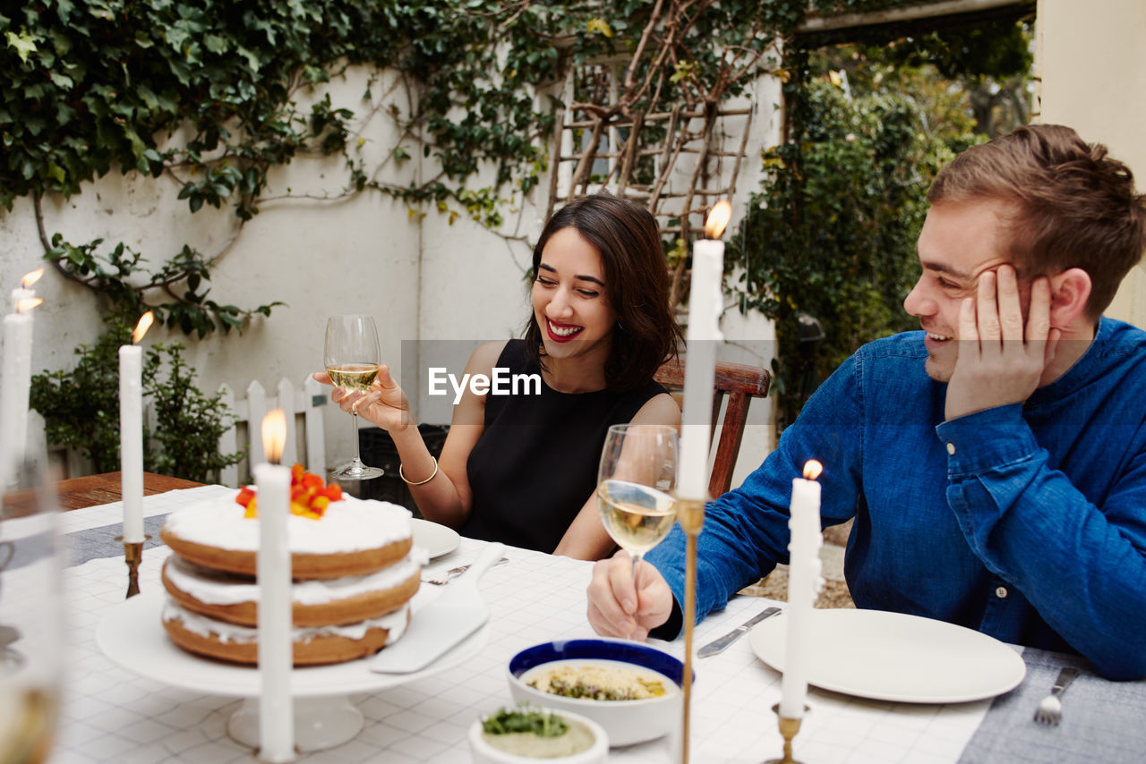 Smiling couple drinking at restaurant