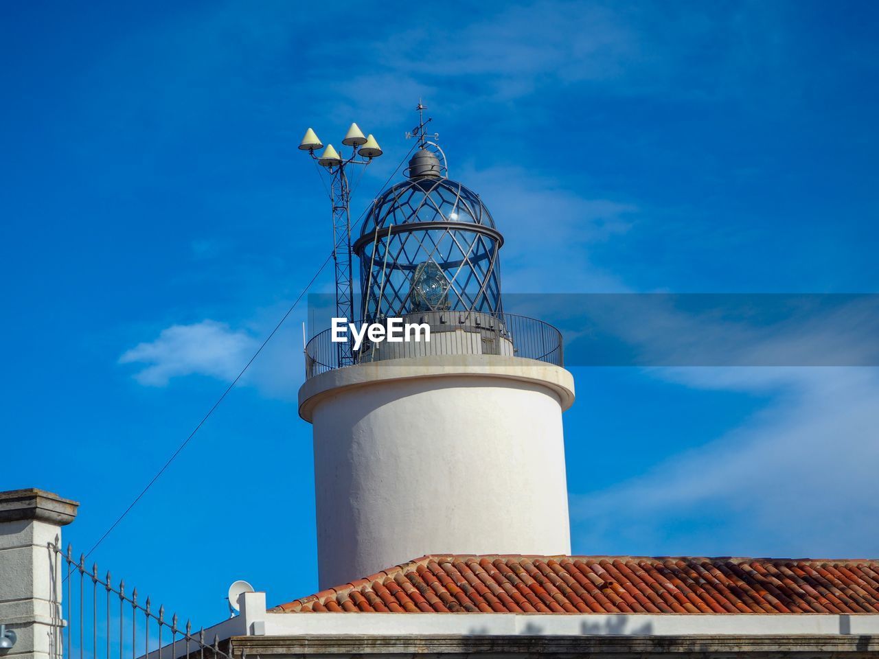 Low angle view of water tower against blue sky