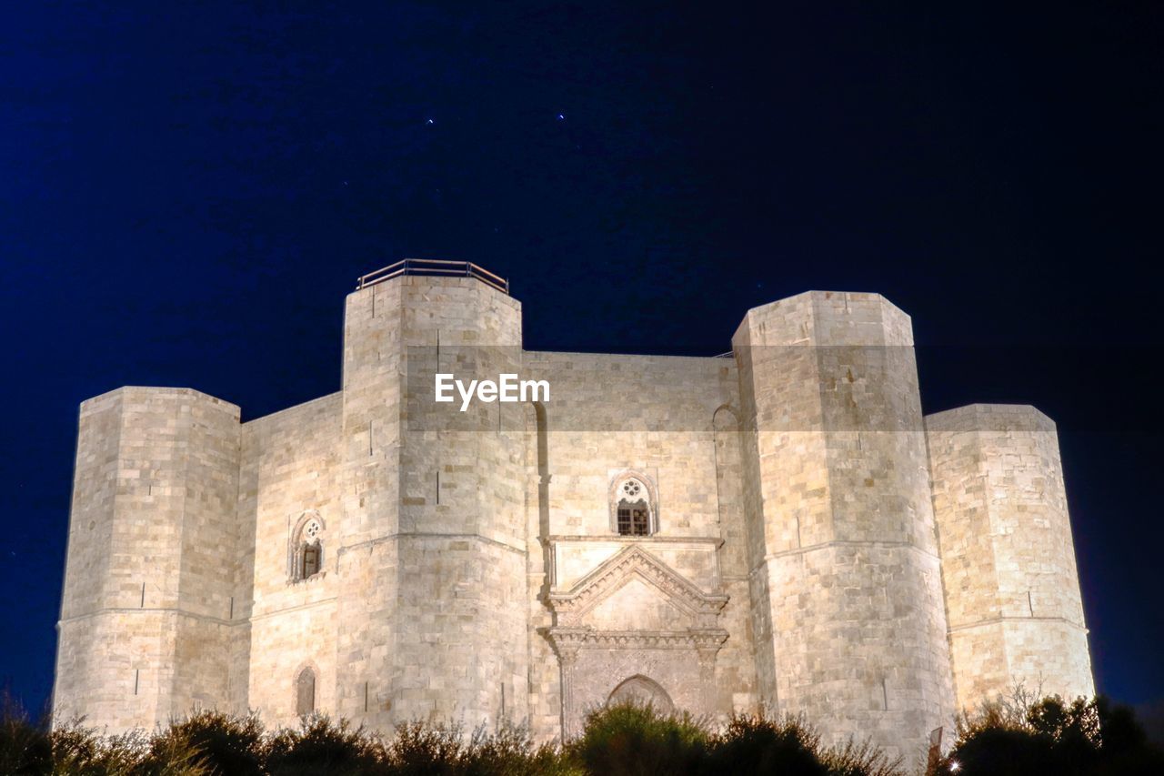 LOW ANGLE VIEW OF CASTLE AGAINST SKY AT NIGHT