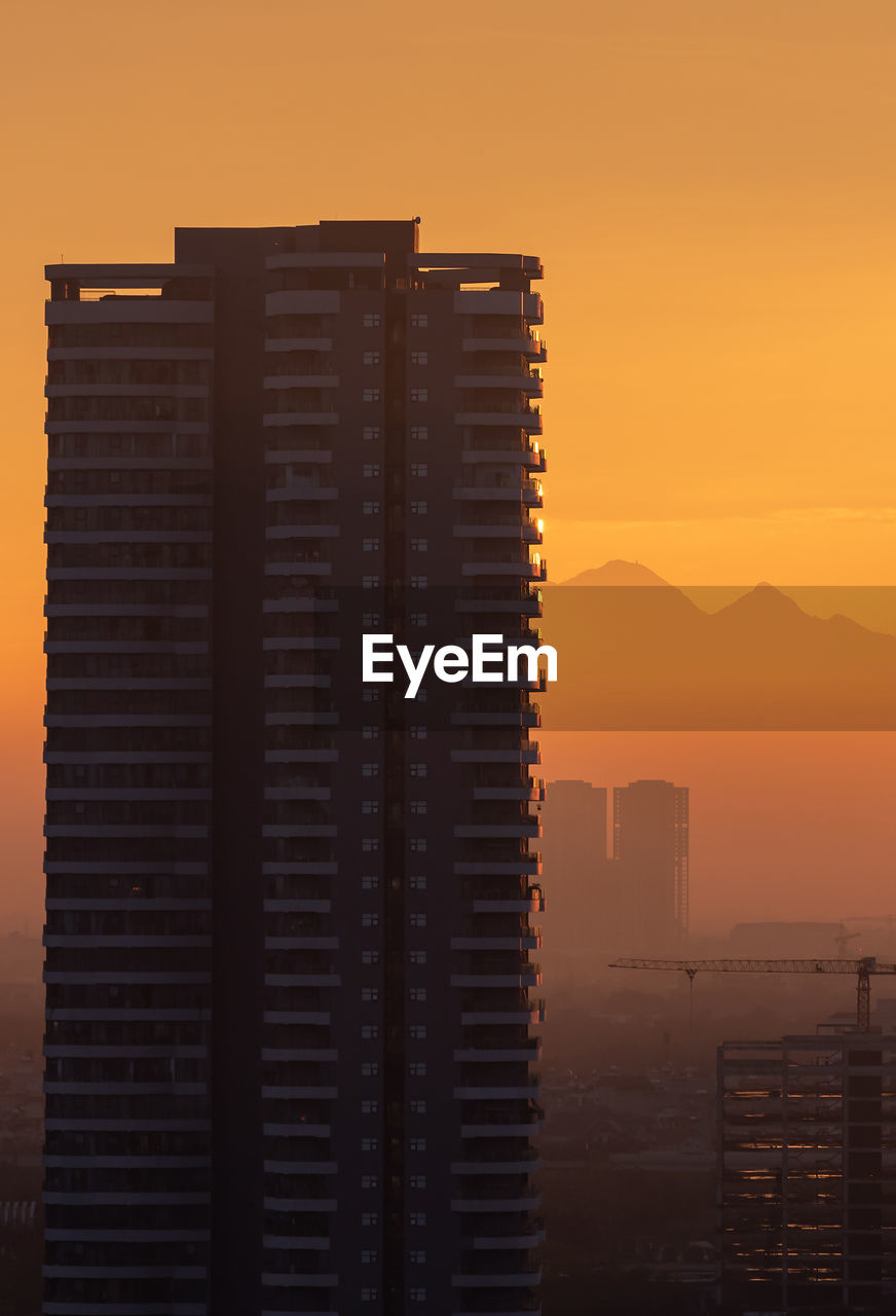 Buildings against sky during sunset