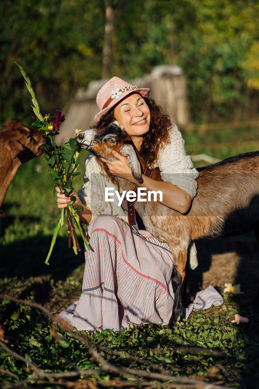 adult, women, one person, nature, animal, animal themes, plant, clothing, smiling, mammal, autumn, happiness, hat, female, emotion, tree, one animal, portrait, domestic animals, young adult, rural scene, flower, horse, lifestyles, landscape, outdoors, person, animal wildlife, land, forest, pet, leisure activity, cheerful, agriculture, day, long hair, beauty in nature, food, grass, positive emotion