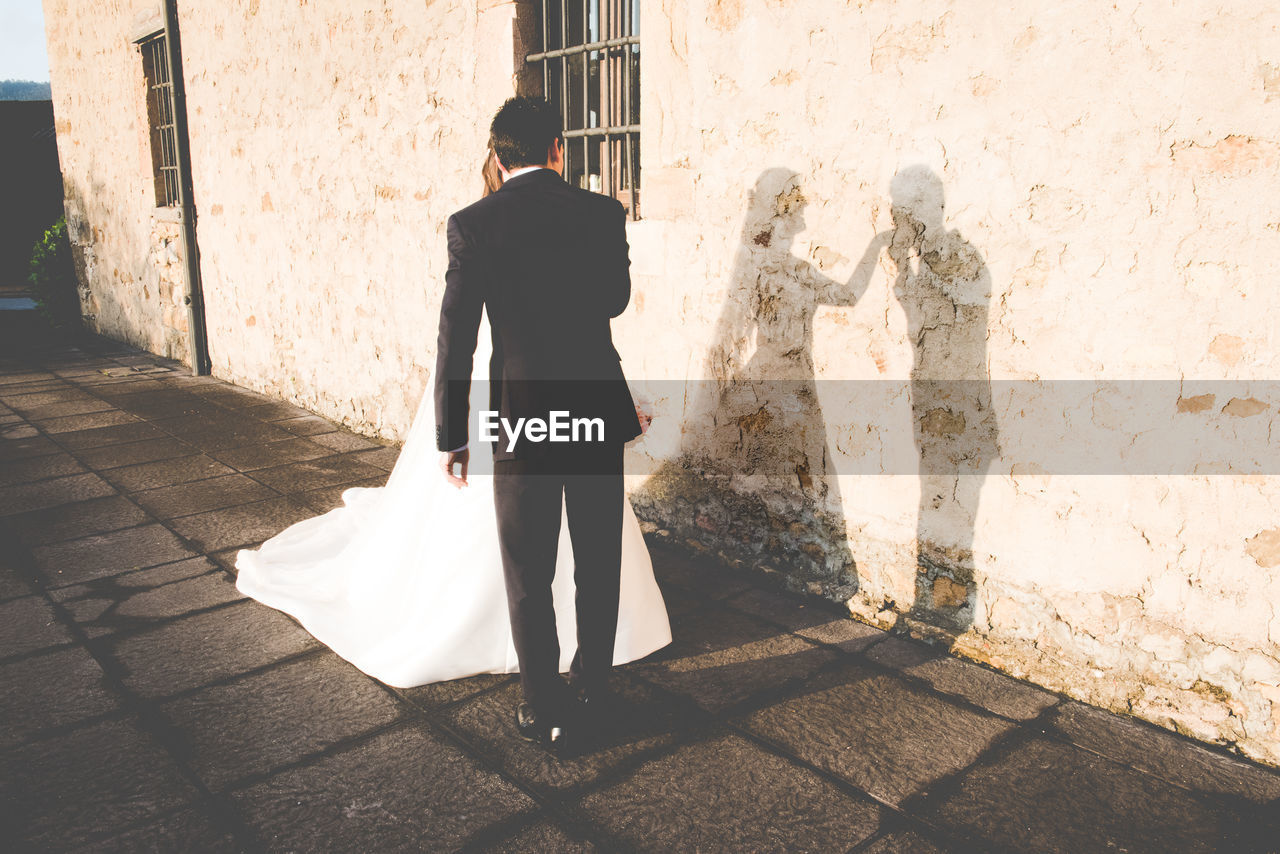 Shadow of married couple on wall