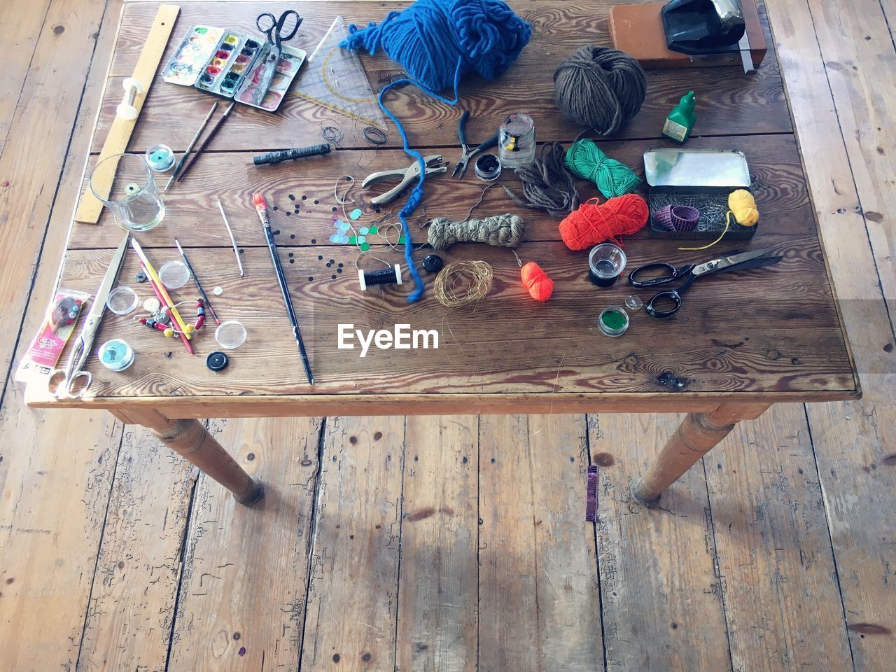 High angle view of sewing items on wooden table