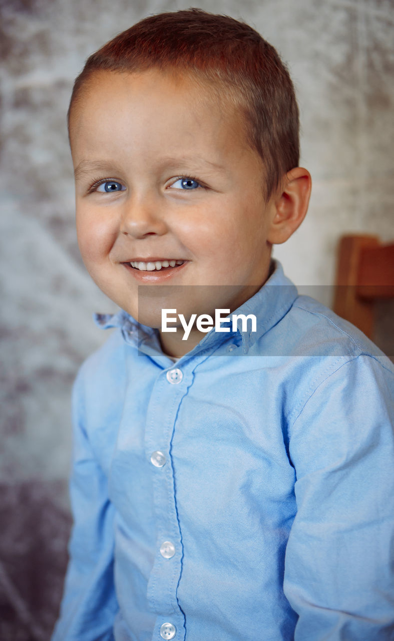 child, childhood, portrait, men, one person, smiling, looking at camera, person, happiness, portrait photography, blue, toddler, emotion, cute, baby, innocence, cheerful, casual clothing, indoors, waist up, skin, human face, positive emotion, lifestyles, front view, standing, brown eyes, shirt, smile