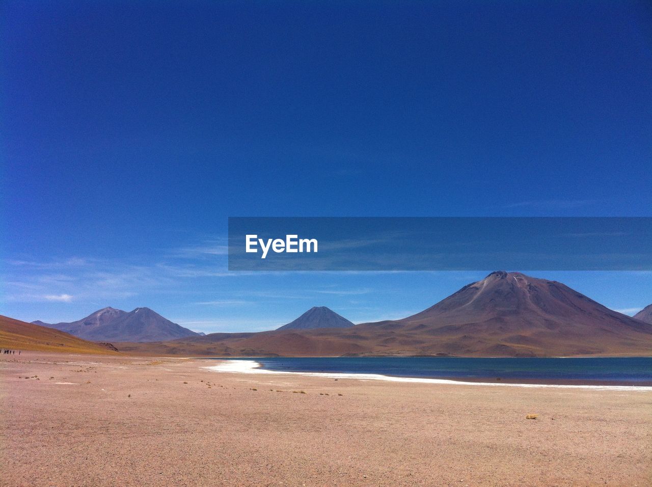 Scenic view of desert against blue sky