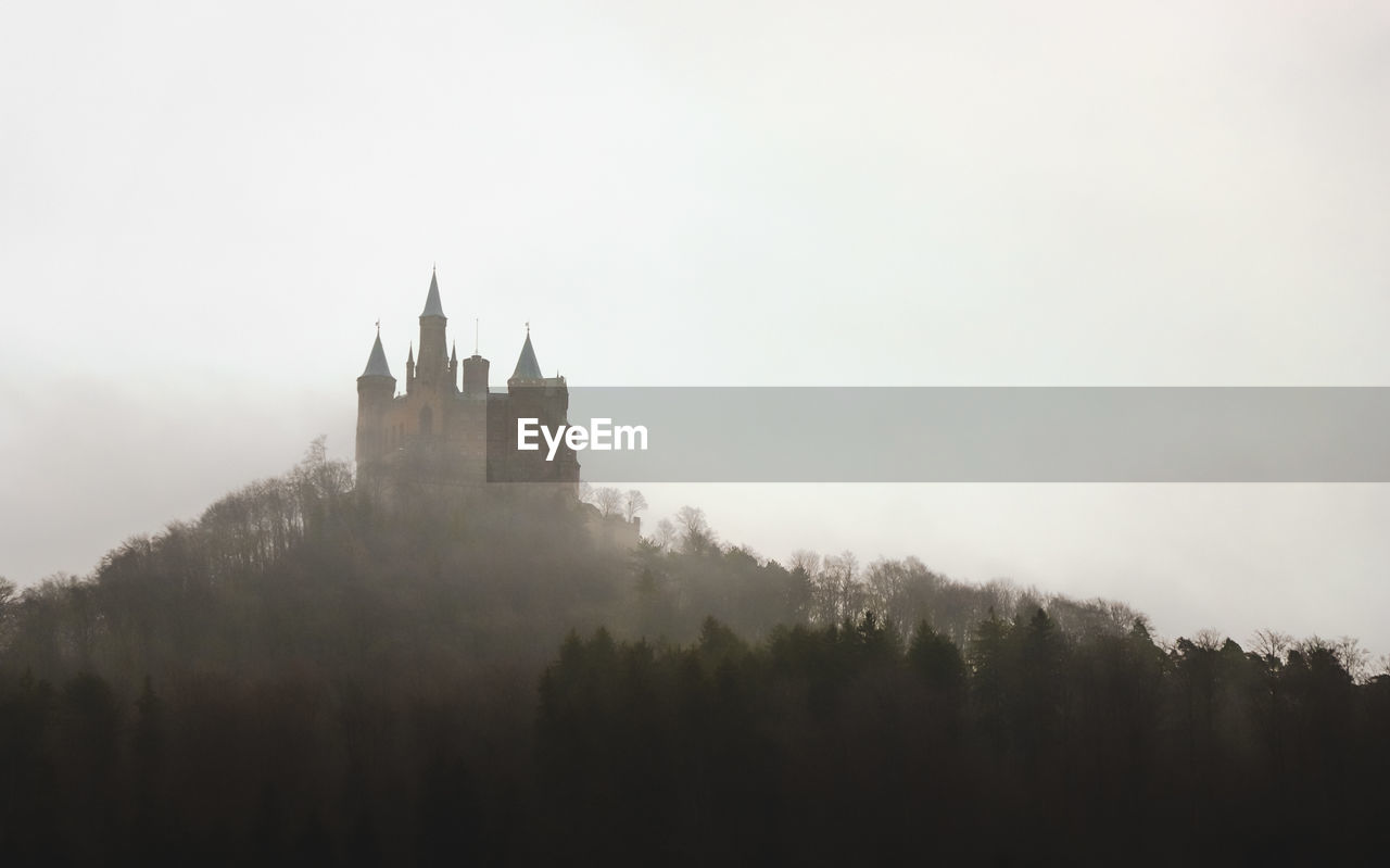 Castle on top of mountain in foggy weather