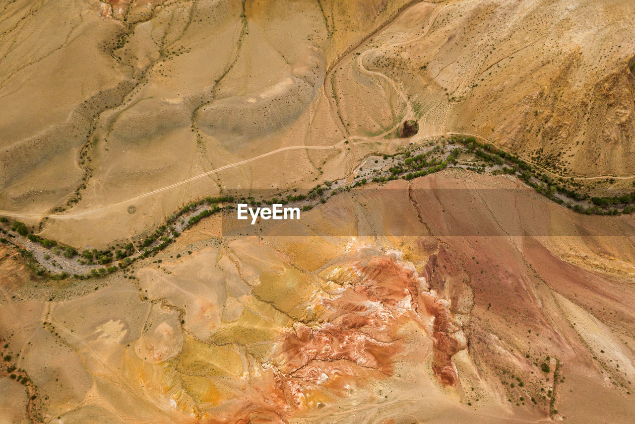A stunning panorama of a mountain chain of peaks, a canyon with red clay, top view. mars 