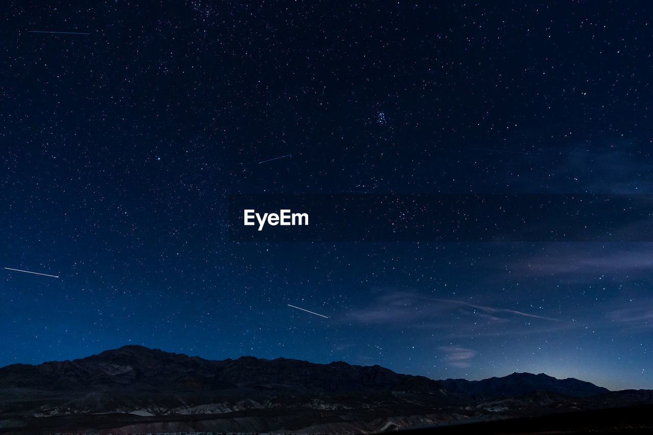 Low angle view of mountains against sky at night