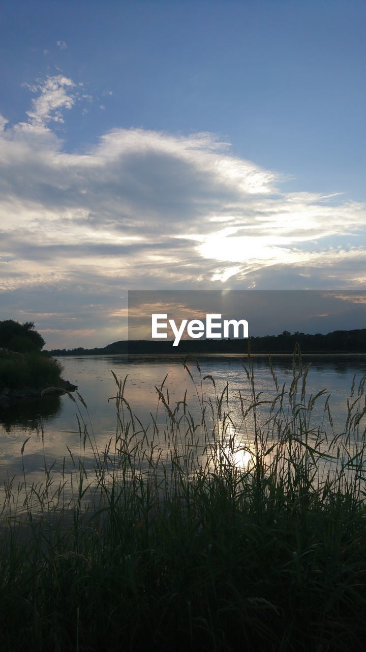 Scenic view of lake against sky during sunset