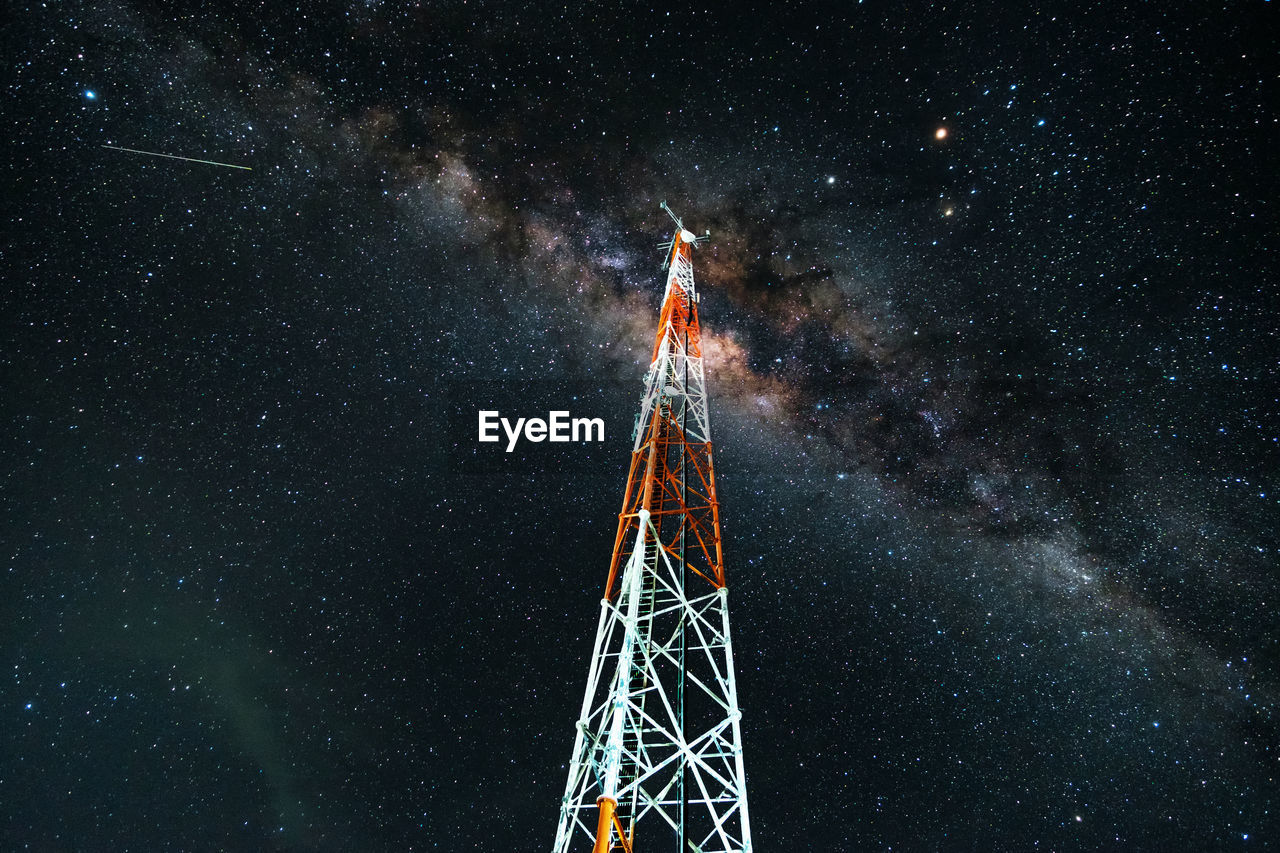 Low angle view of milky way across the telecom tower