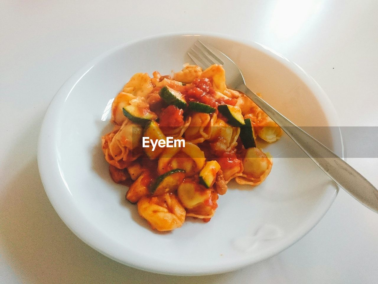 CLOSE-UP OF PASTA WITH MEAT AND SALAD IN PLATE