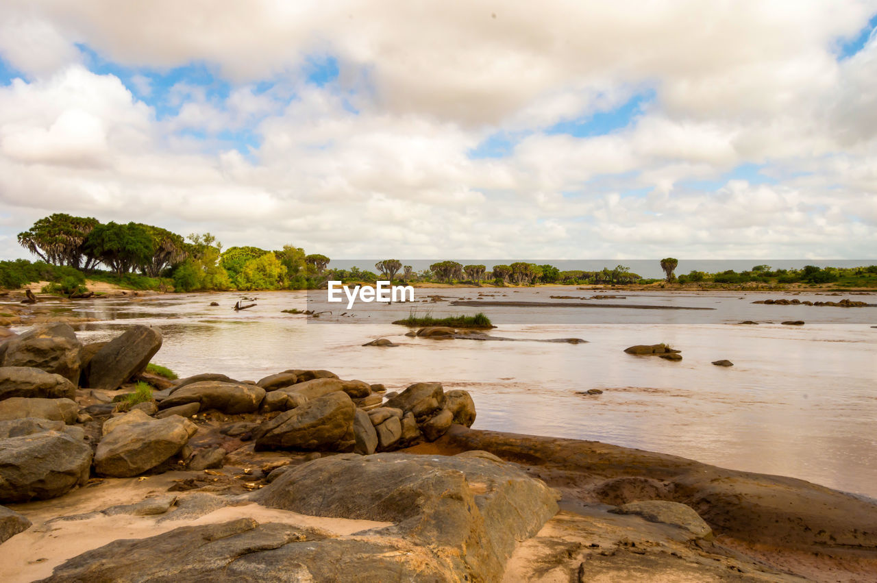 water, sky, sea, shore, land, cloud, beach, coast, nature, body of water, rock, environment, scenics - nature, travel destinations, travel, landscape, beauty in nature, ocean, coastline, tree, trip, vacation, tourism, tranquility, holiday, sand, plant, island, tropical climate, outdoors, no people, bay, seascape, tranquil scene, cove, water's edge, architecture, wave, horizon, palm tree, summer, day, bay of water, relaxation, animal wildlife, idyllic, cloudscape