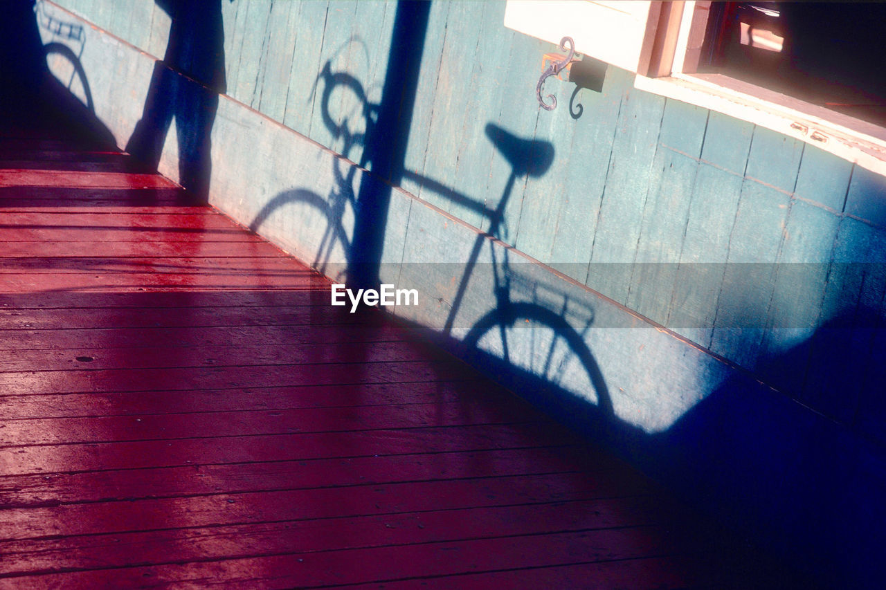 High angle view of bicycle shadow on staircase