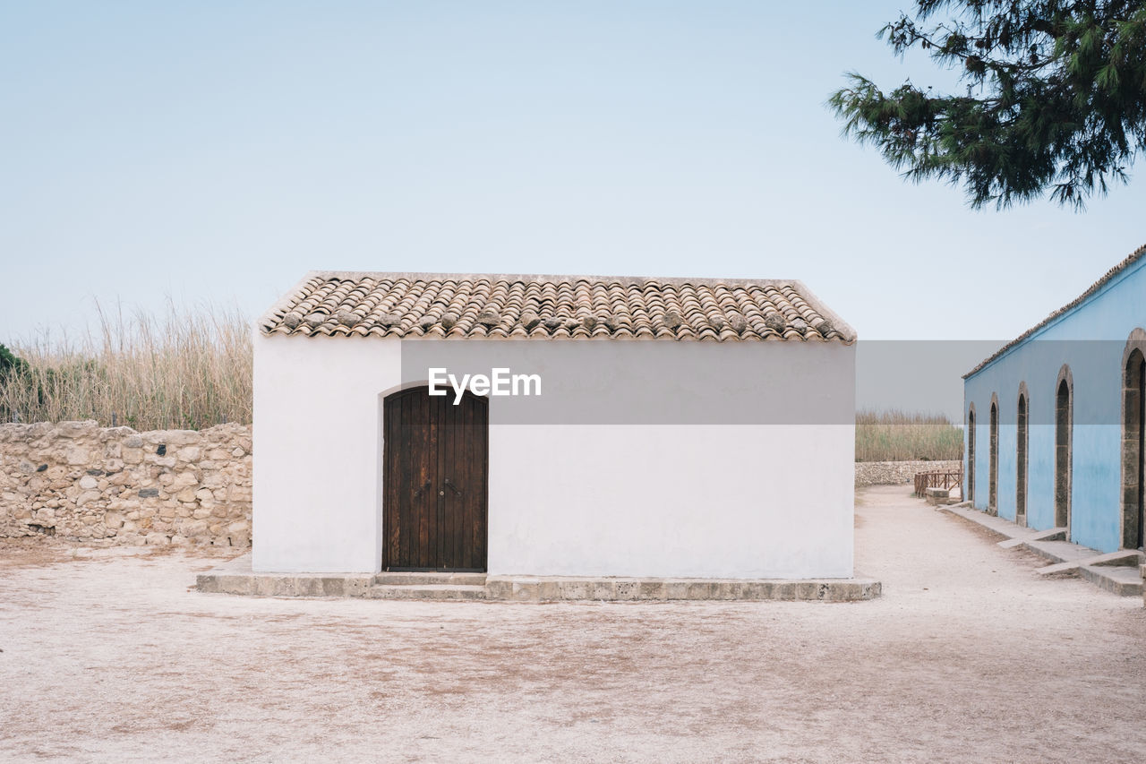 Built structure on field against clear sky