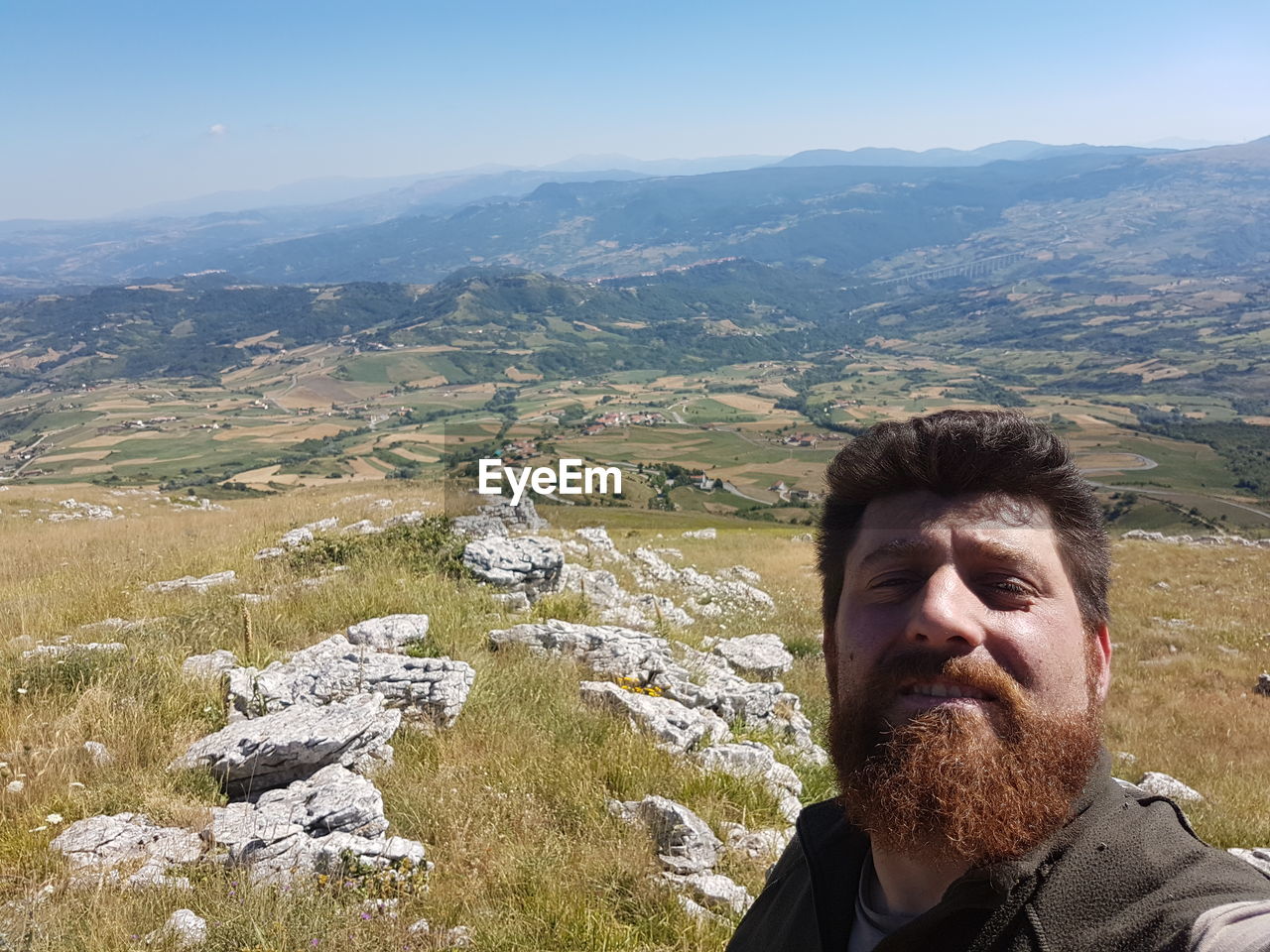 Portrait of man on mountain against sky