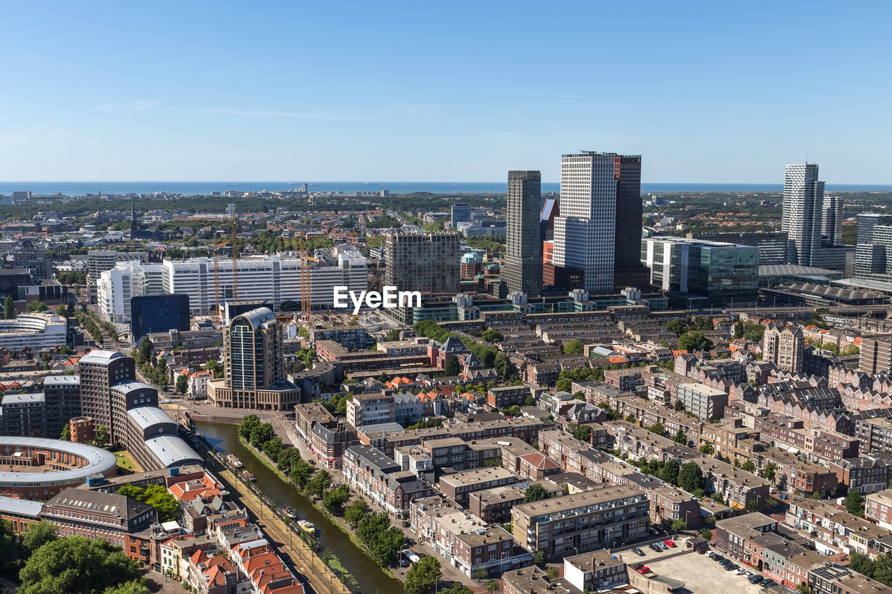 High angle view of modern buildings in city against sky