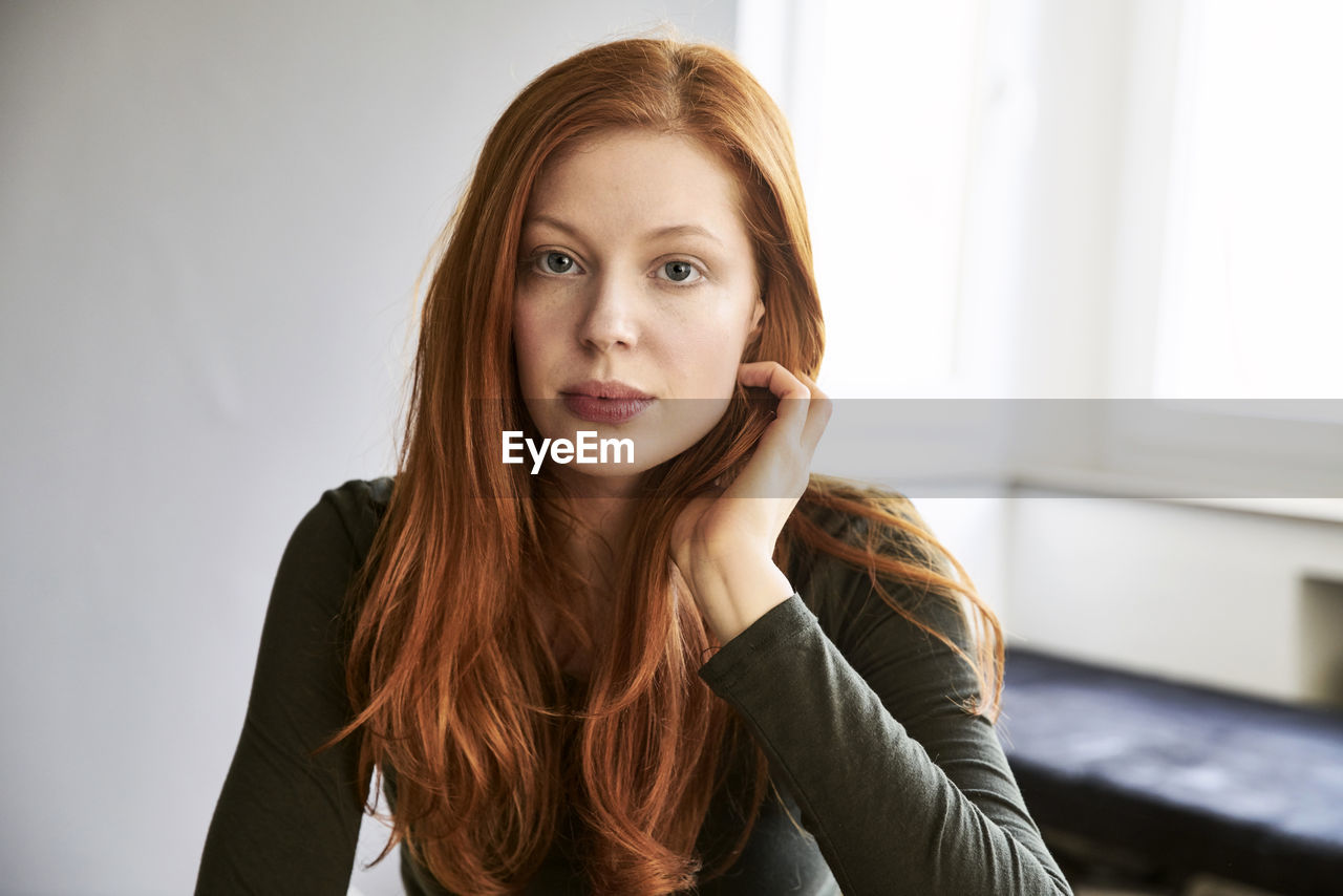 Portrait of serious redheaded woman