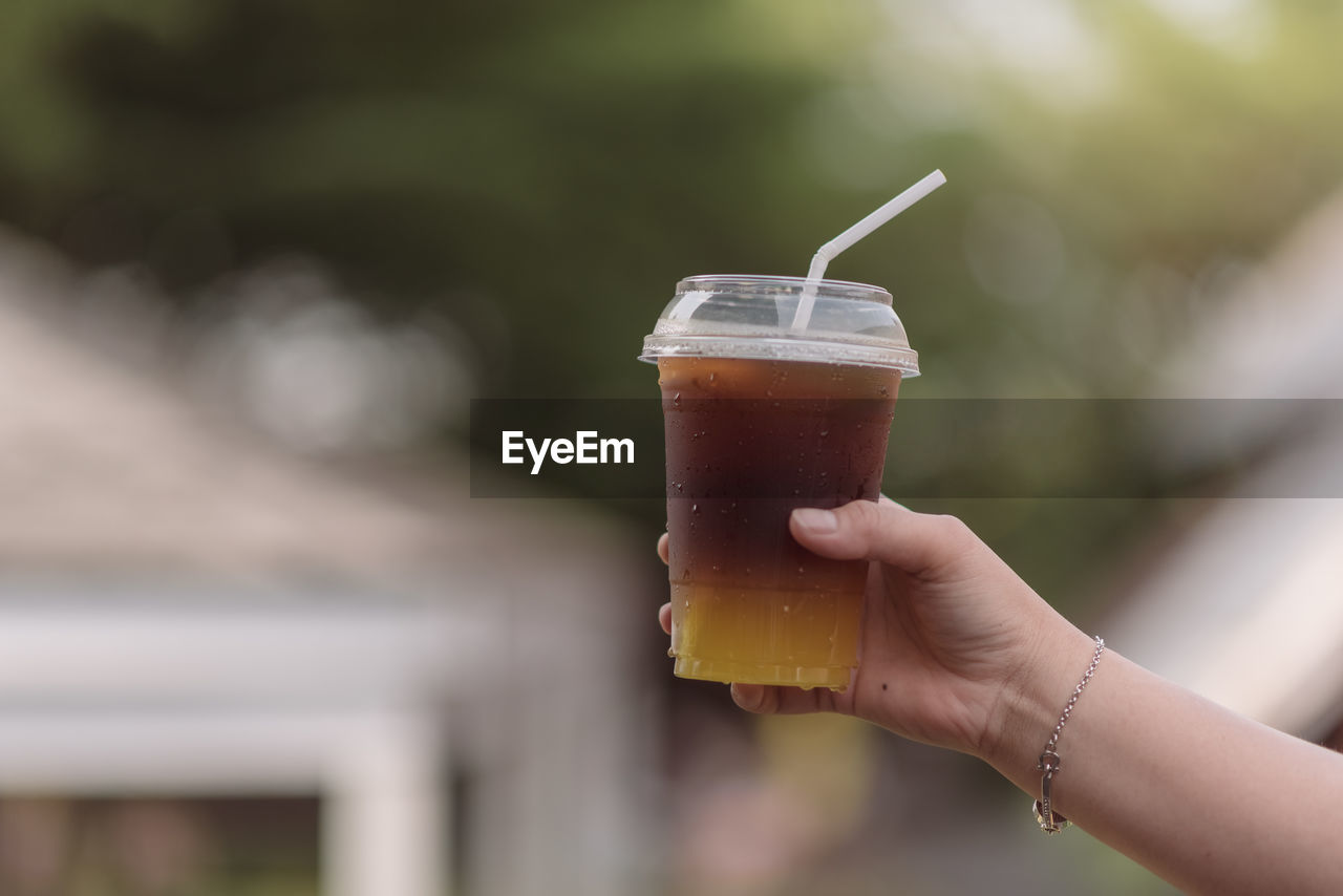 close-up of hand holding beer glass