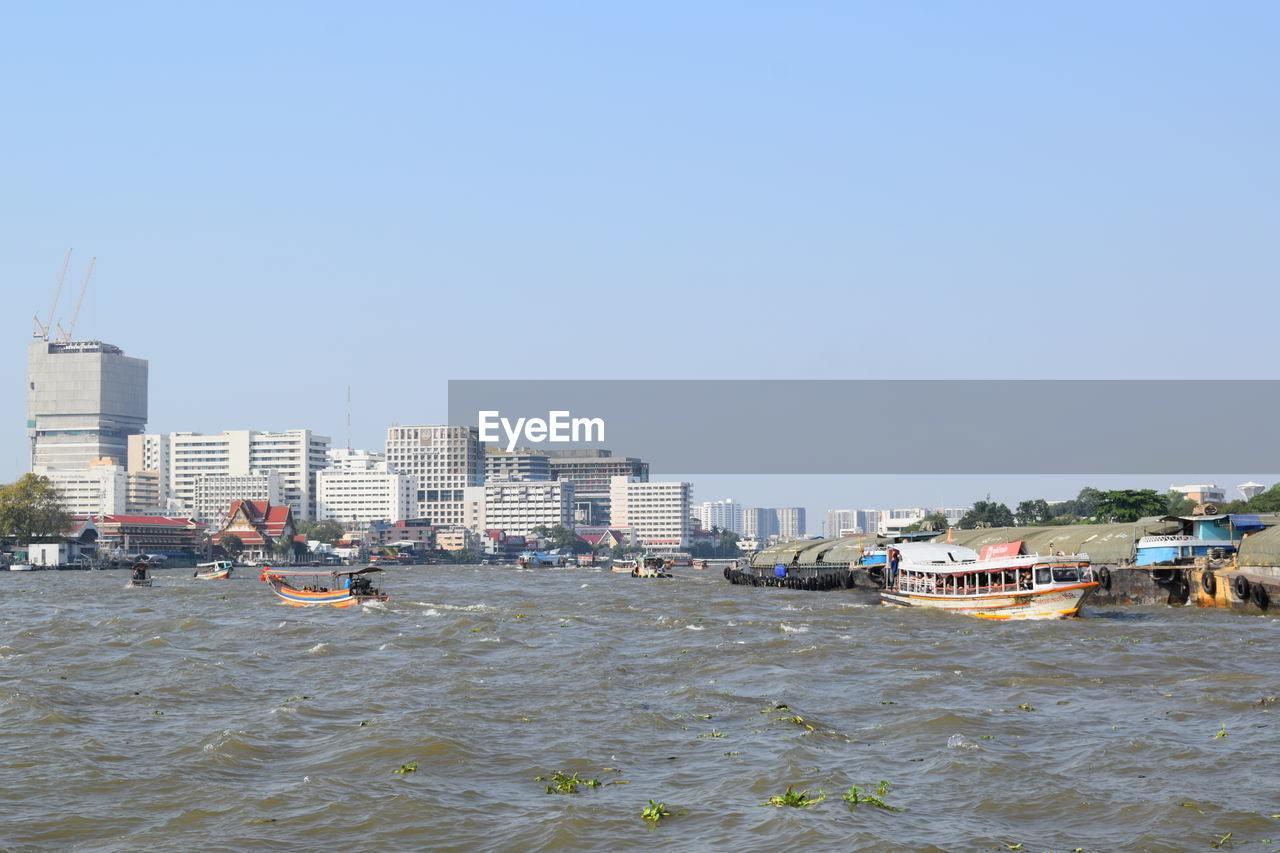 SCENIC VIEW OF SEA AGAINST BUILDINGS