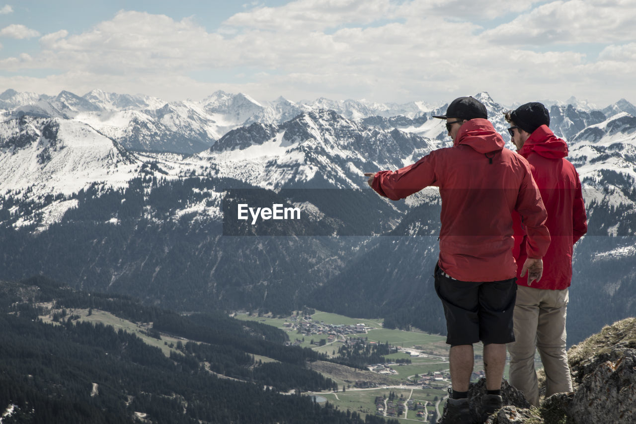 Rear view of men against european alps