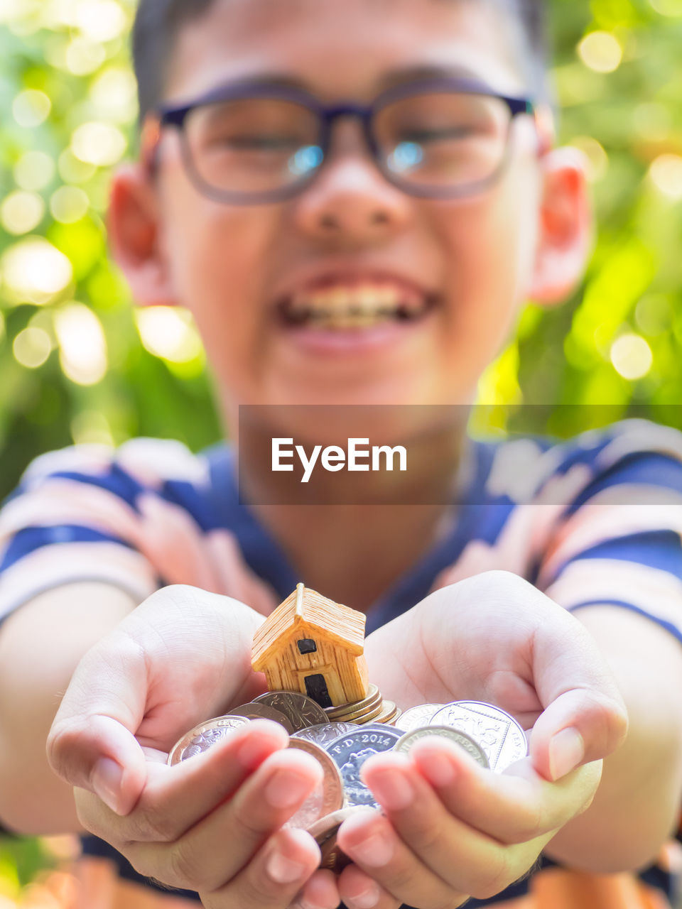 Smiling boy holding coins