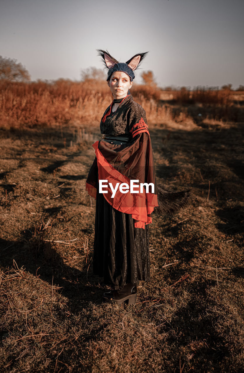 Full length of woman wearing costume standing on field