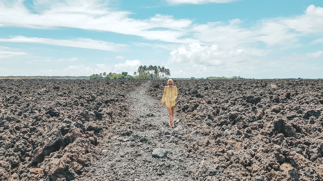 Full length of woman walking on land against sky